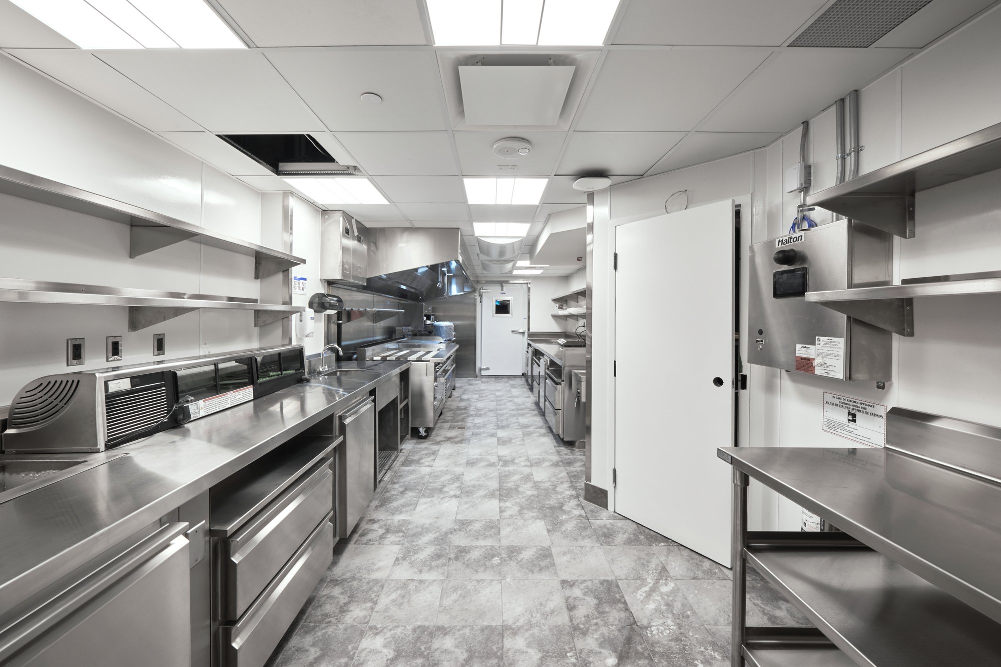 Commercial kitchen buildout with stainless equipment and finished line