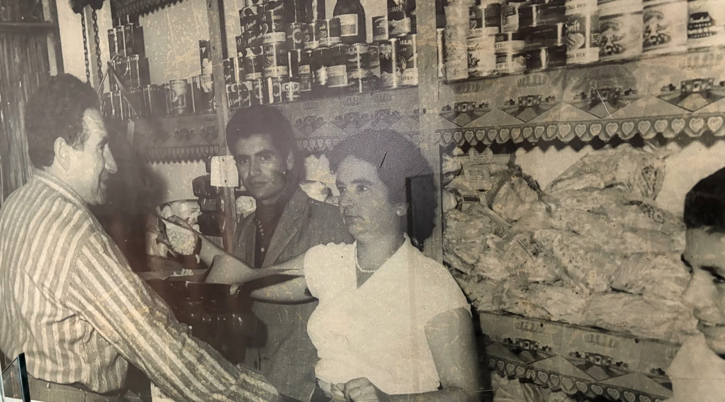 Cesario family grocery store in Argentina, family behind the counter with stocked shelves