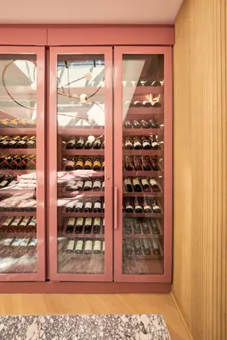close view of bottles racked behind glass cabinet doors