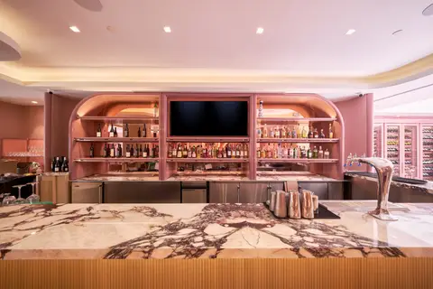bar with an arched backbar, marble counter and draught tower