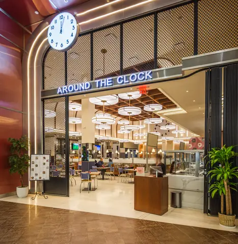 Around the Clock storefront and illuminated clock sign on the mall concourse