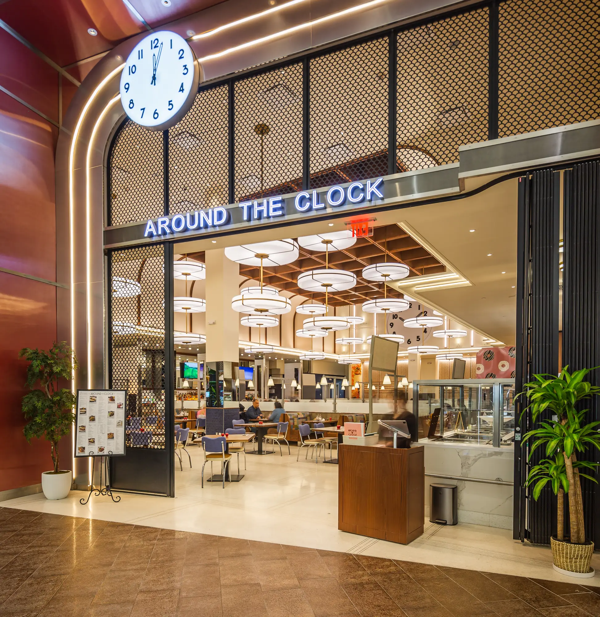 Around the Clock storefront and illuminated clock sign on the mall concourse