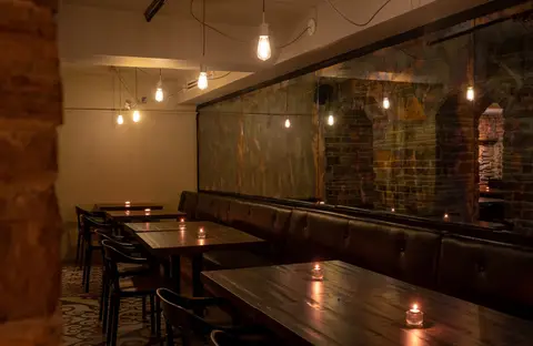 banquette seating reflected in a long wall mirror