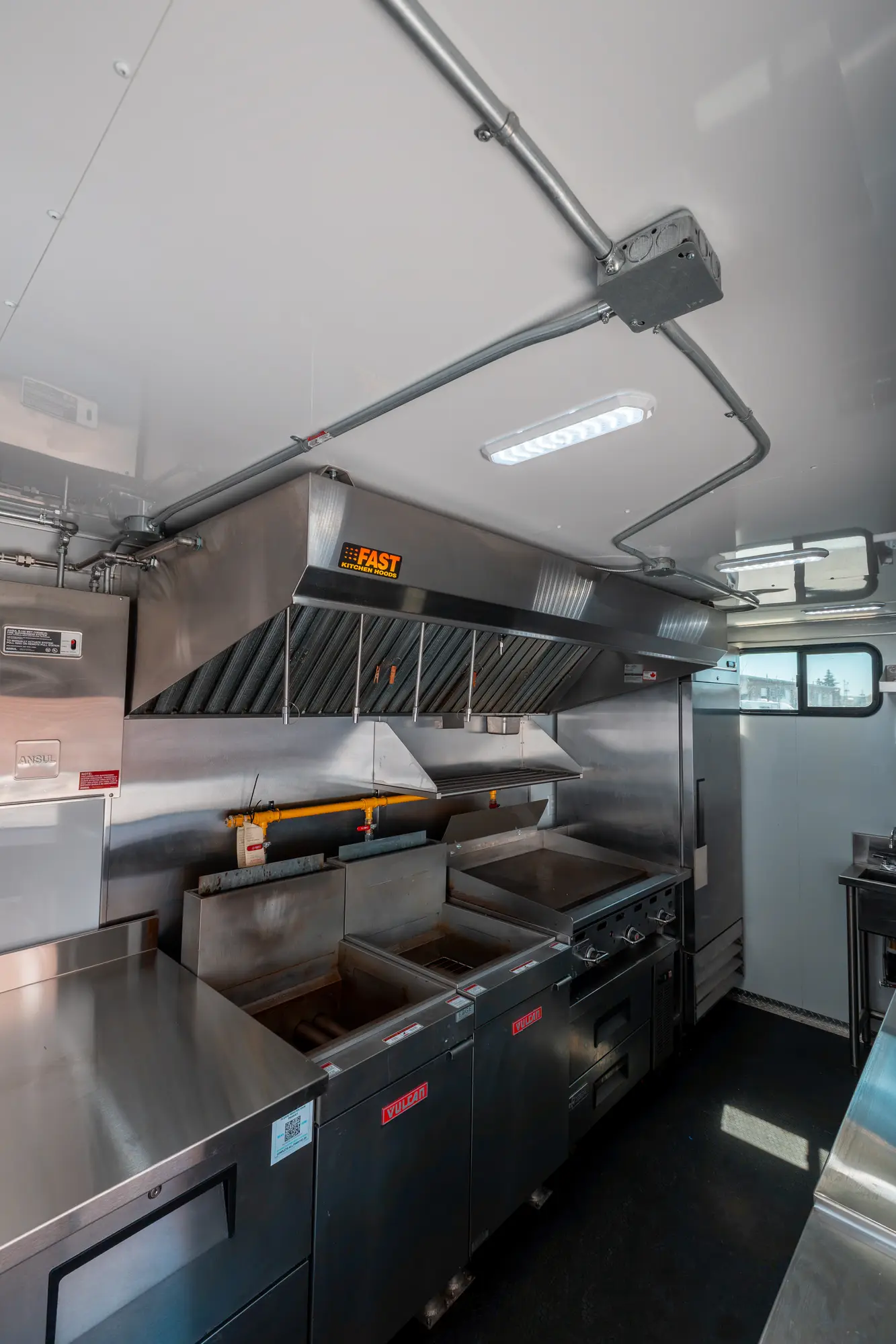 fryers under the ventilation canopy inside the trailer