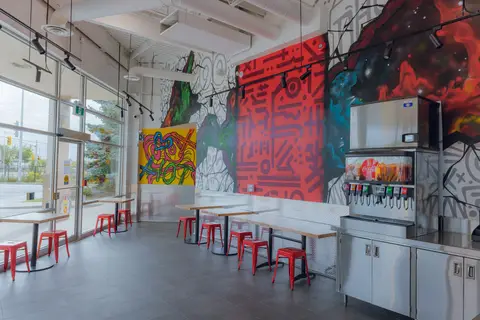 dining room with communal tables along a window wall