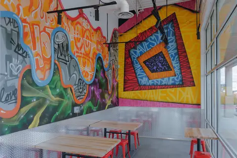 corner seating beneath a painted mural
