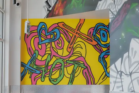 yellow and pink mural panel on the dining room wall