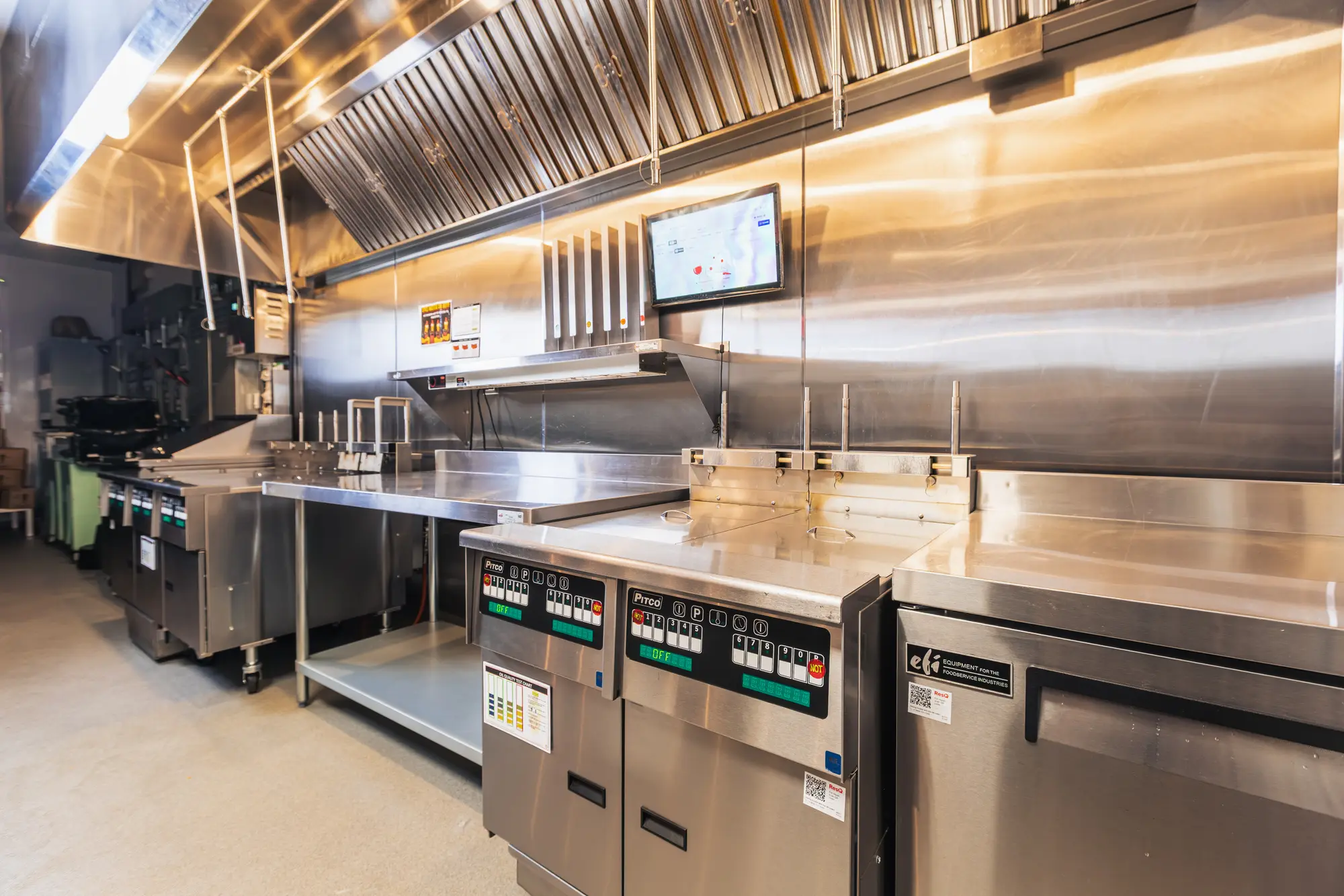 Fryer battery under the ventilation canopy at Dave's Hot Chicken Pickering