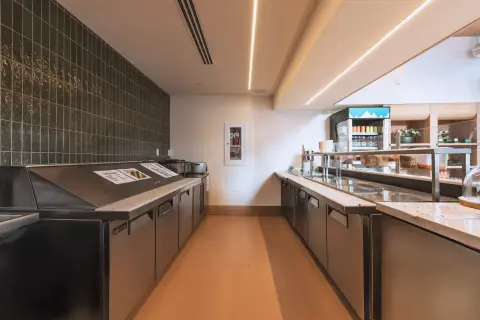 Stainless refrigerated prep line behind the Farmhouse counter