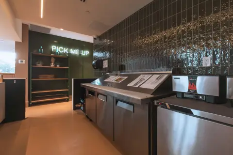 Pick-up shelf and prep line under a Pick Me Up sign
