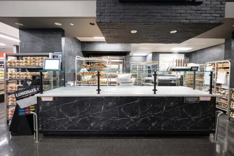 bakery service counter in dark marble with racks behind