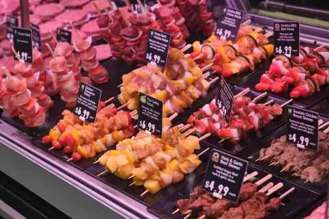 close view of marinated skewers with price cards