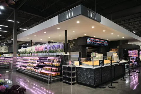 pizza counter beside refrigerated displays
