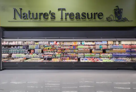 refrigerated natural foods wall under a Nature's Treasure sign