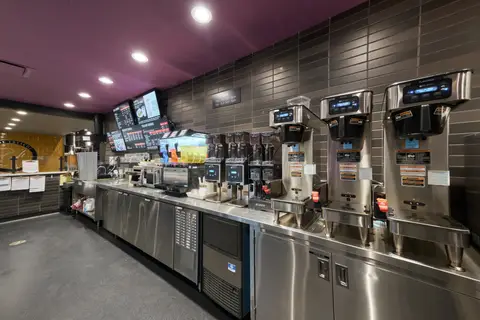 cafe servery with beverage equipment and menu boards