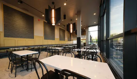 dine-in seating area with bentwood chairs beside the windows