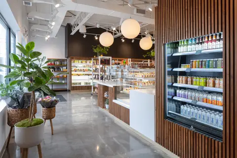 Freebird Market interior with slatted walnut, open cases and globe pendants