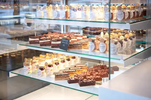 glass pastry case with plated desserts
