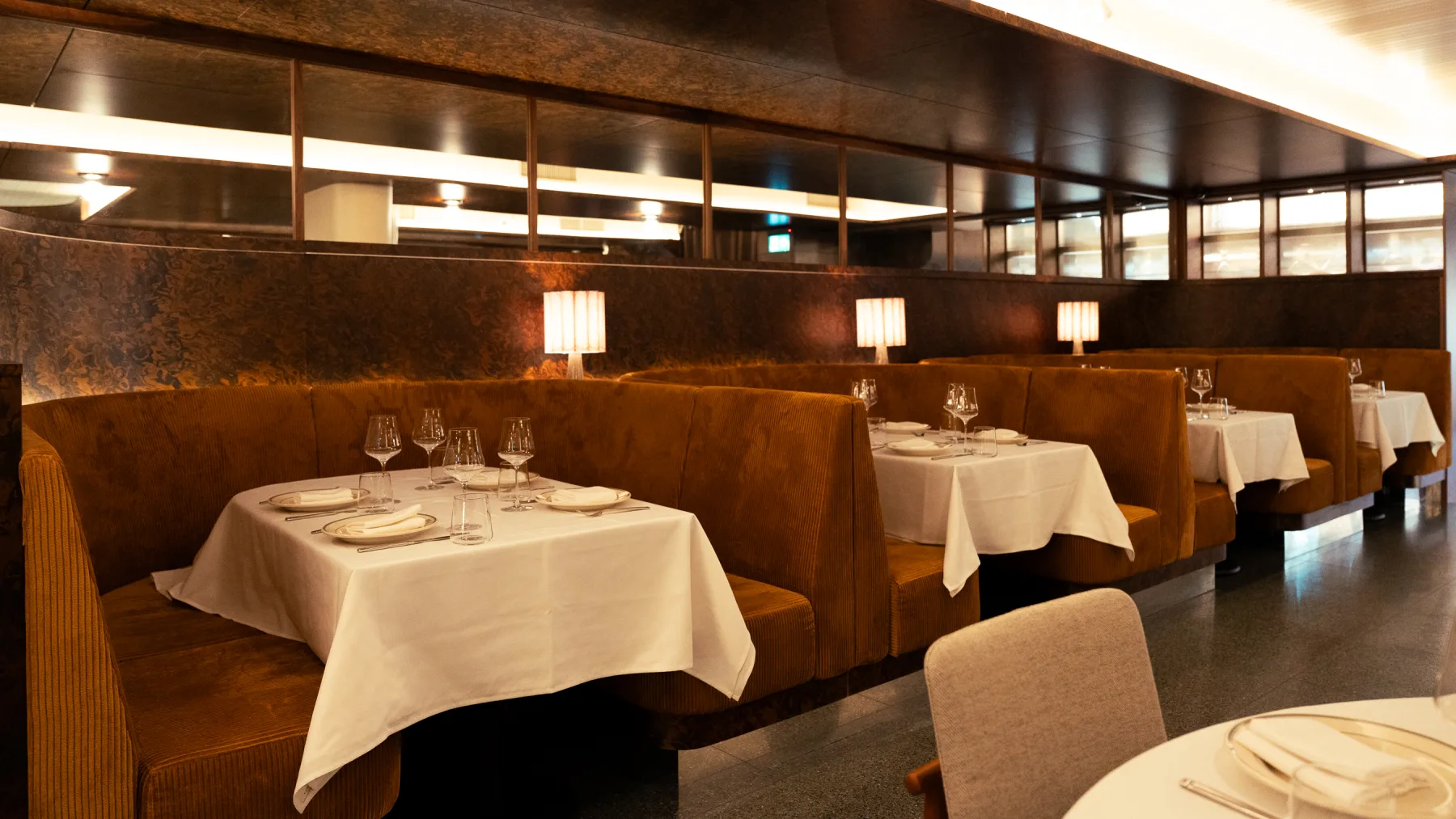 Linny's finished dining room with banquettes and set tables