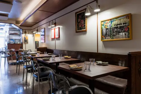 N.L. Ginzburg dining room with banquettes and artwork