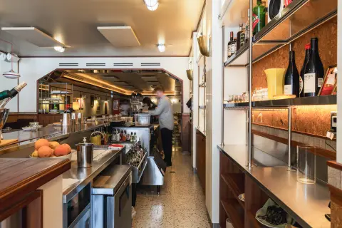 View from the bar into the open kitchen