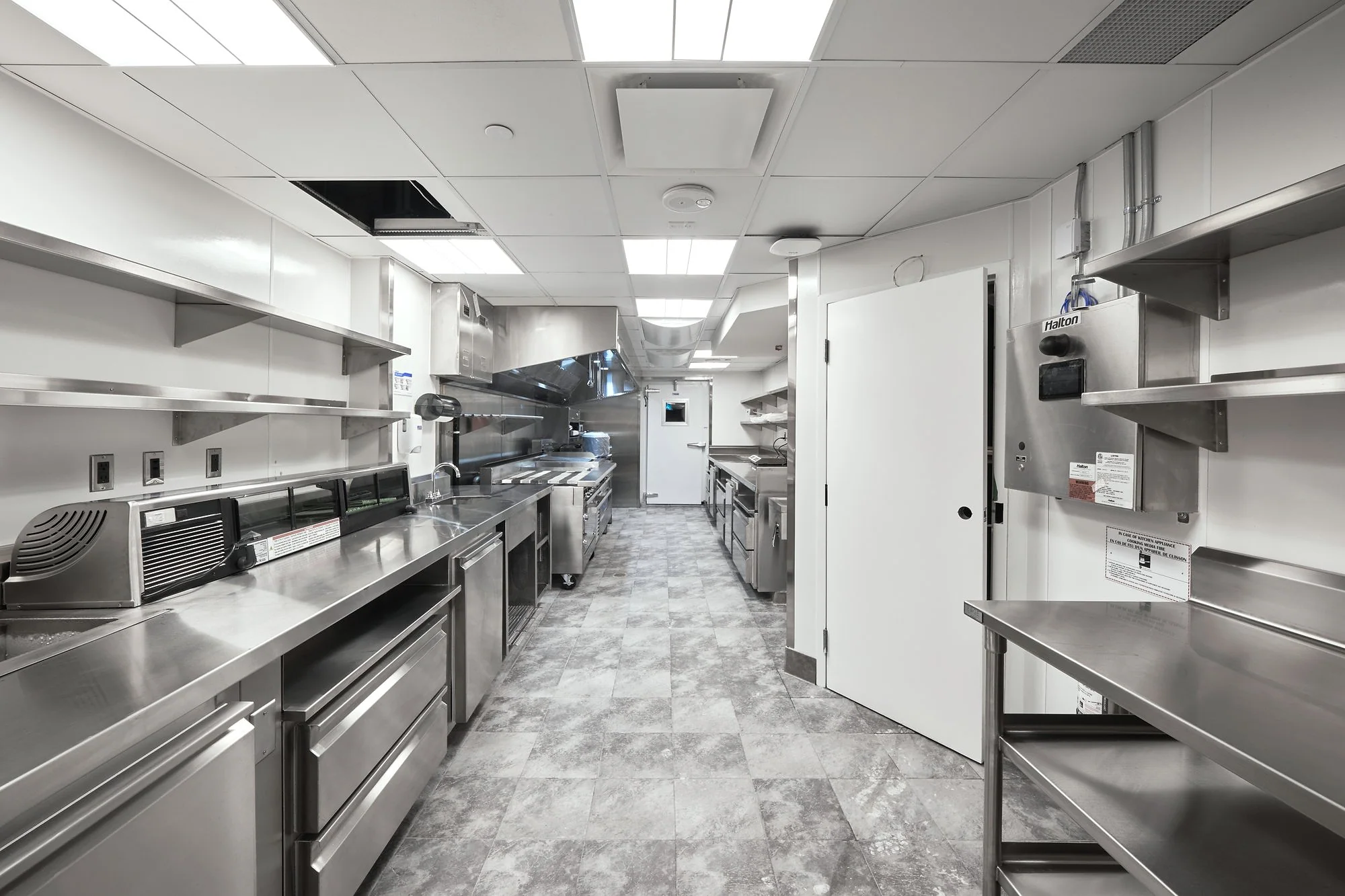 Commercial kitchen buildout with stainless equipment and finished line