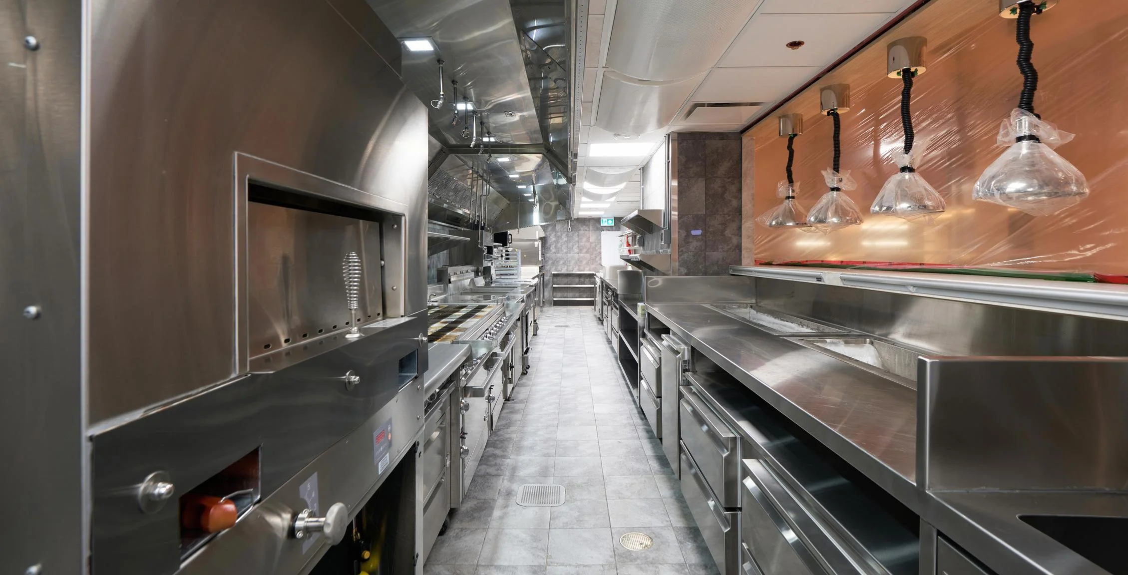 Nobu Toronto cook line with pass lights and stainless equipment