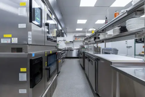 Combi ovens and stainless worktables in the Petros82 kitchen