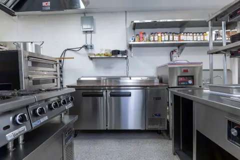 Petros82 prep kitchen with range and refrigerated work surface
