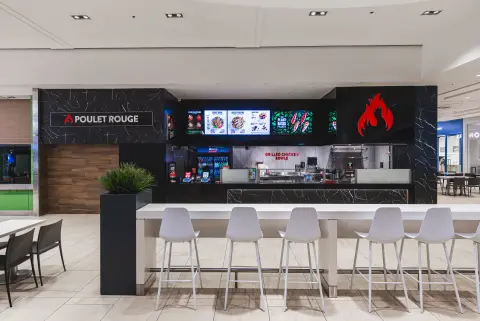 Poulet Rouge counter seating and branded storefront
