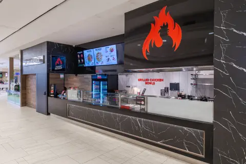 Poulet Rouge ordering counter under the flame sign