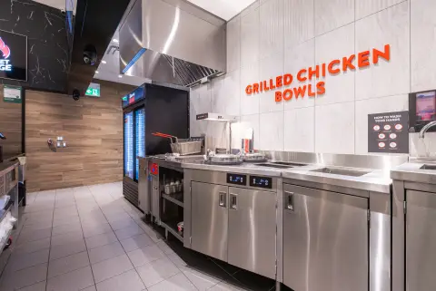 Grilled chicken bowls station with stainless counters