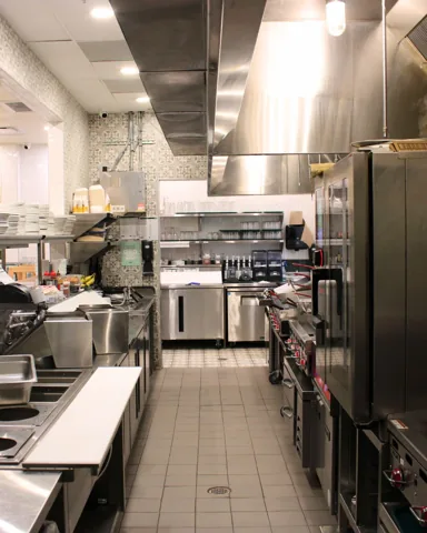 Pür & Simple San Antonio cooking line beneath a stainless ventilation hood