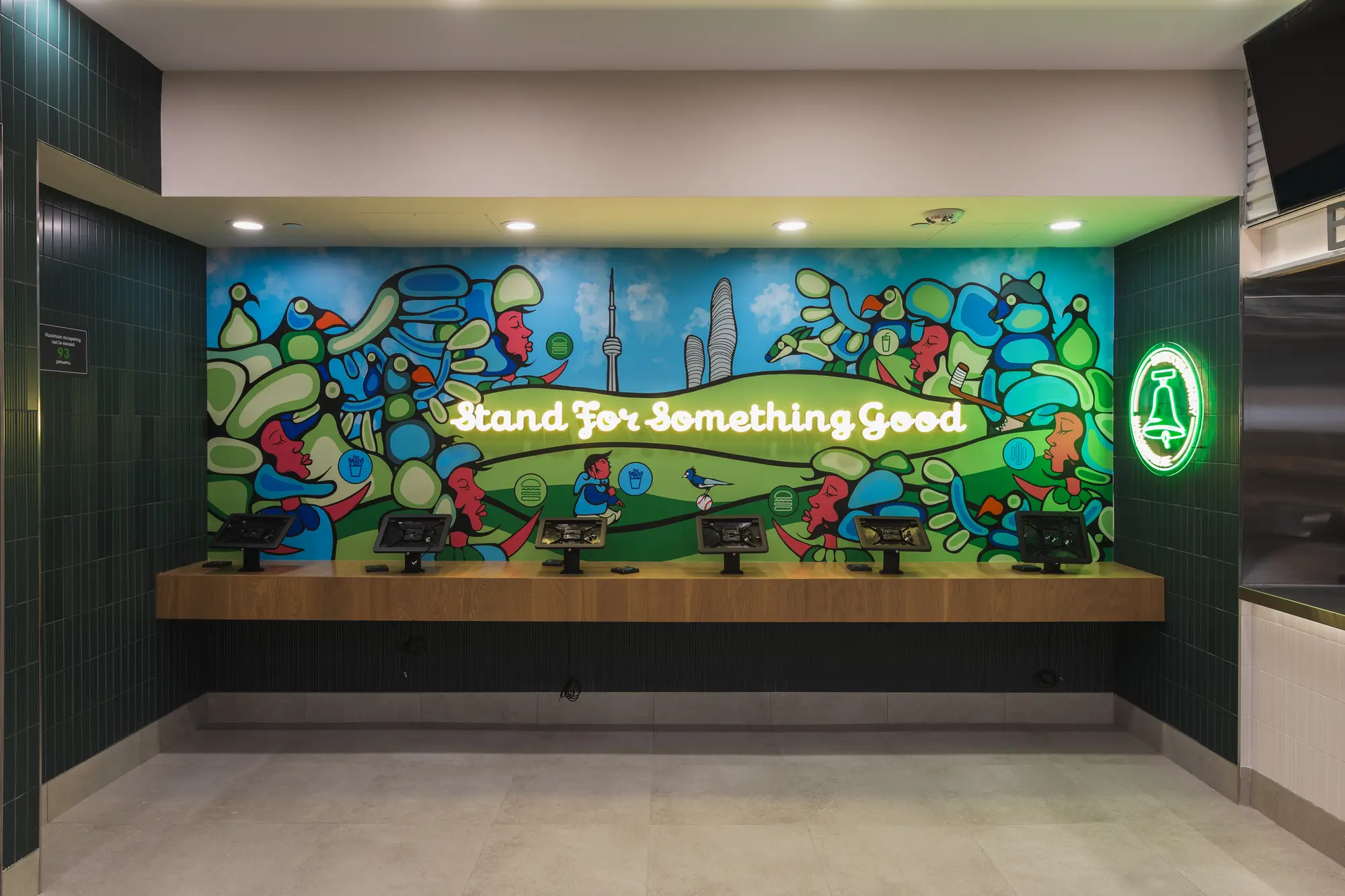 Shake Shack Square One dining area with mural wall and bench seating