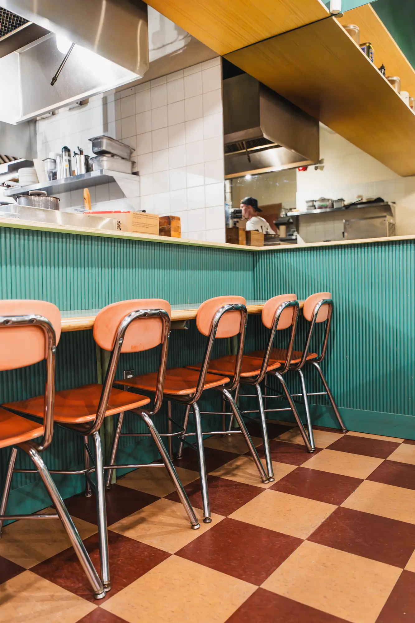 counter seating and stools facing the open kitchen