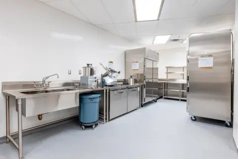 Prep area with sinks, slicer and reach-in refrigeration
